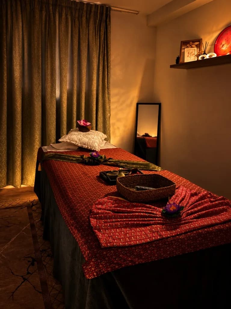 Massage room with a Thai silk table cover and candles