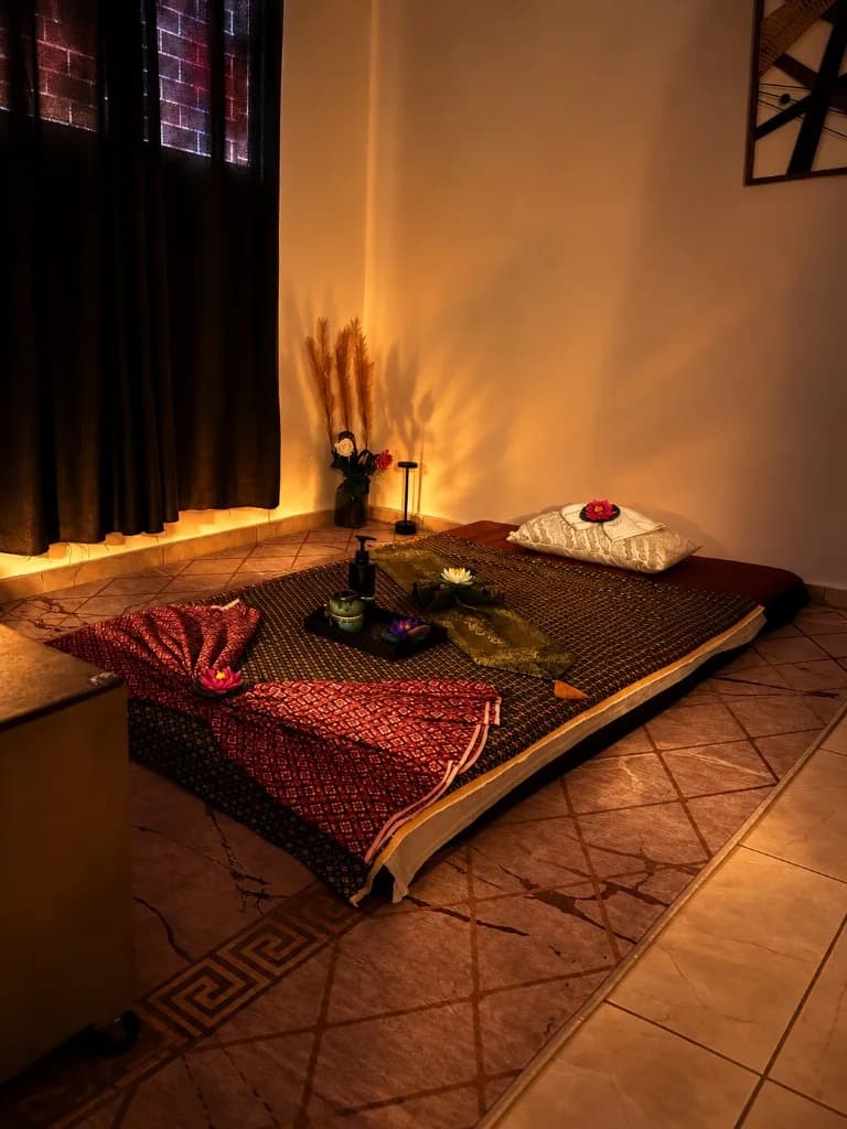 Traditional Thai massage mat lit by lanterns