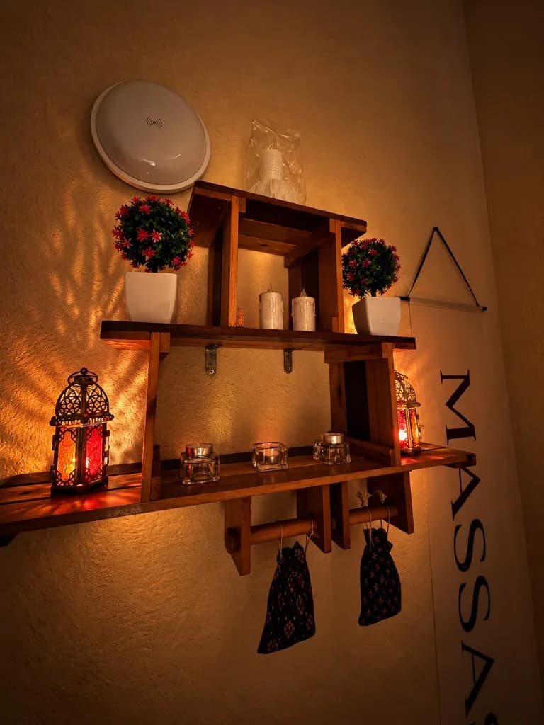 Wooden shelf with lanterns and candles